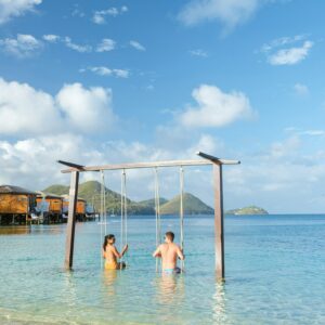 Couple in a swing on the beach of the tropical Island Saint Lucia or St Lucia Caribbean