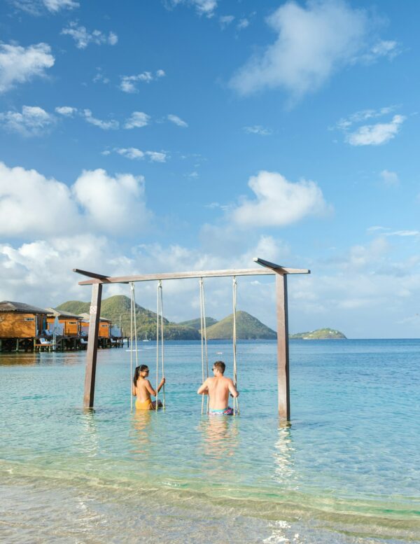 Couple in a swing on the beach of the tropical Island Saint Lucia or St Lucia Caribbean